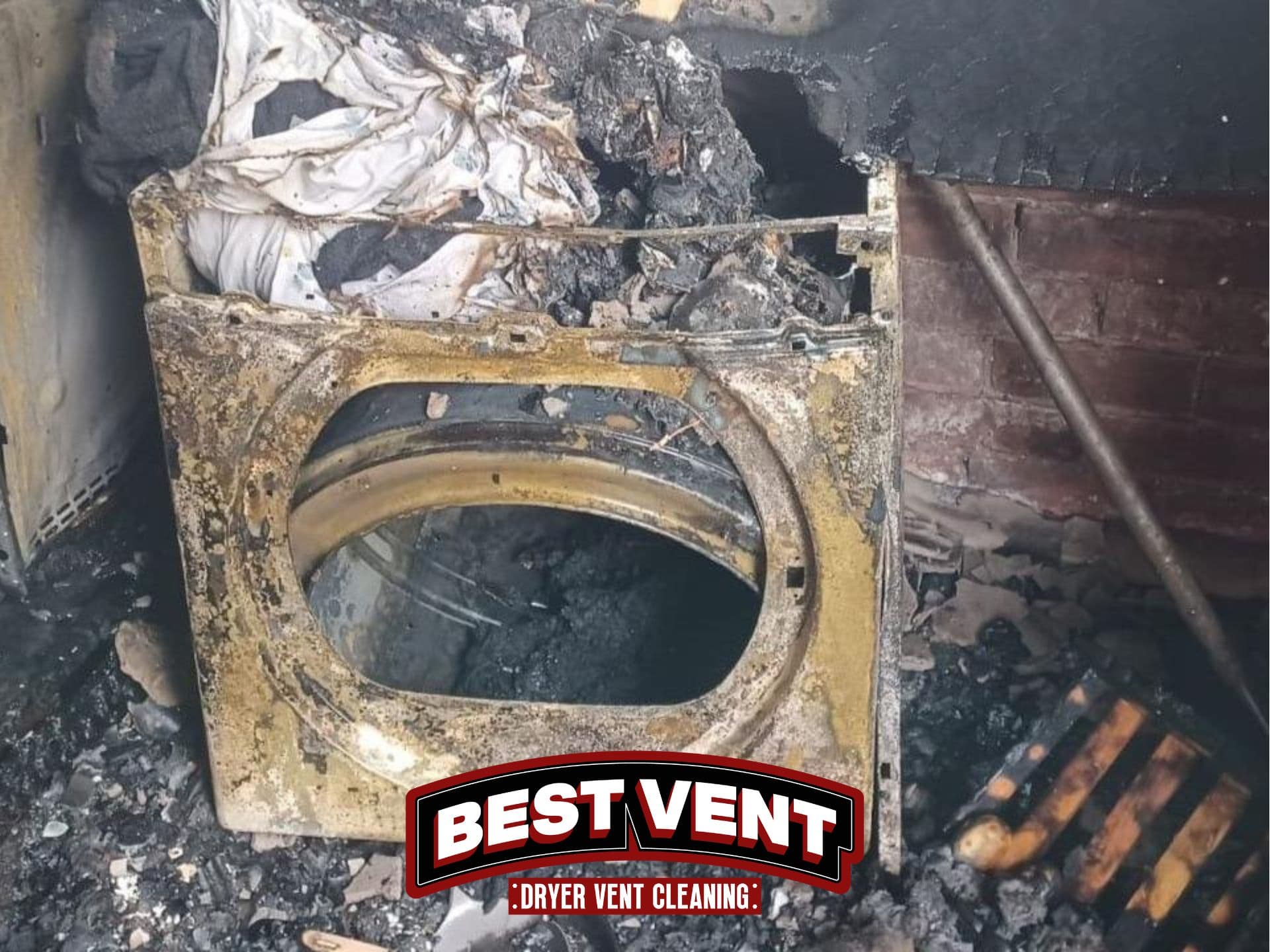 Severely fire-damaged dryer with charred debris and ash, featuring Best Vent Dryer Vent Cleaning logo.