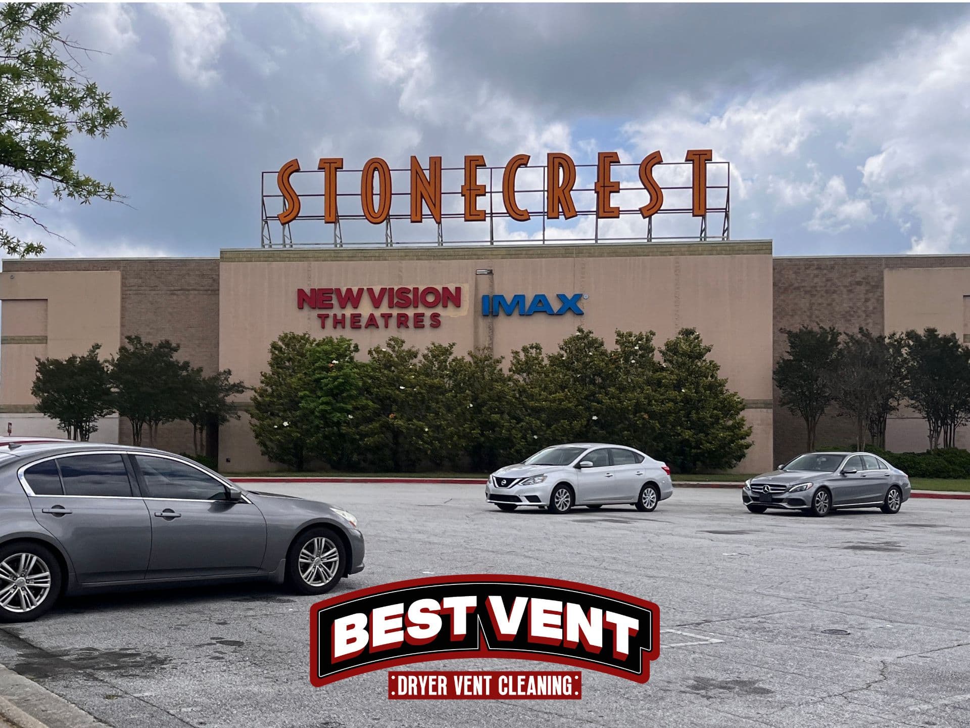 Stonecrest New Vision Theatres building with cars in the parking lot and Best Vent logo.
