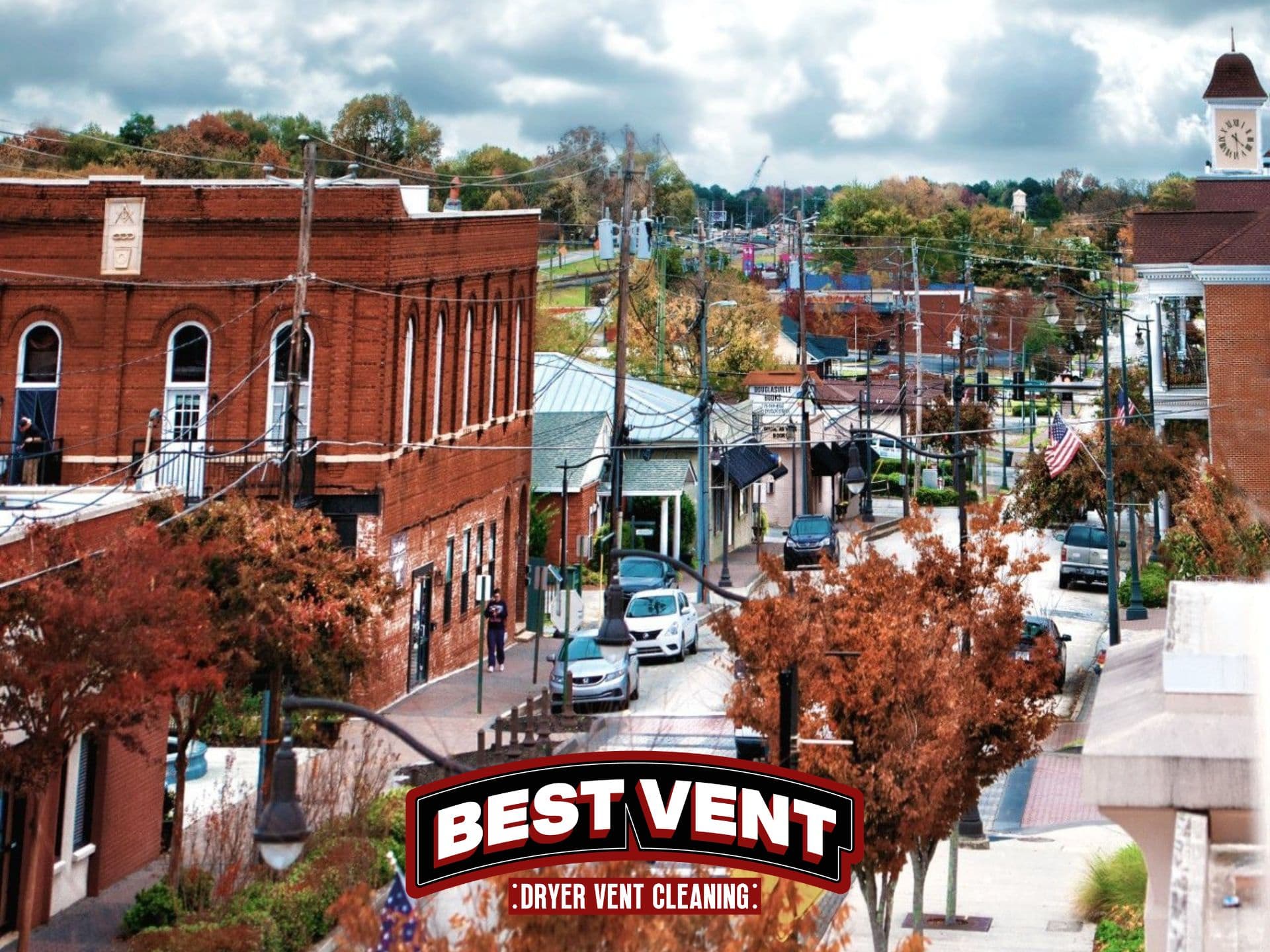 Small town street with autumn trees and a Best Vent Dryer Vent Cleaning logo.