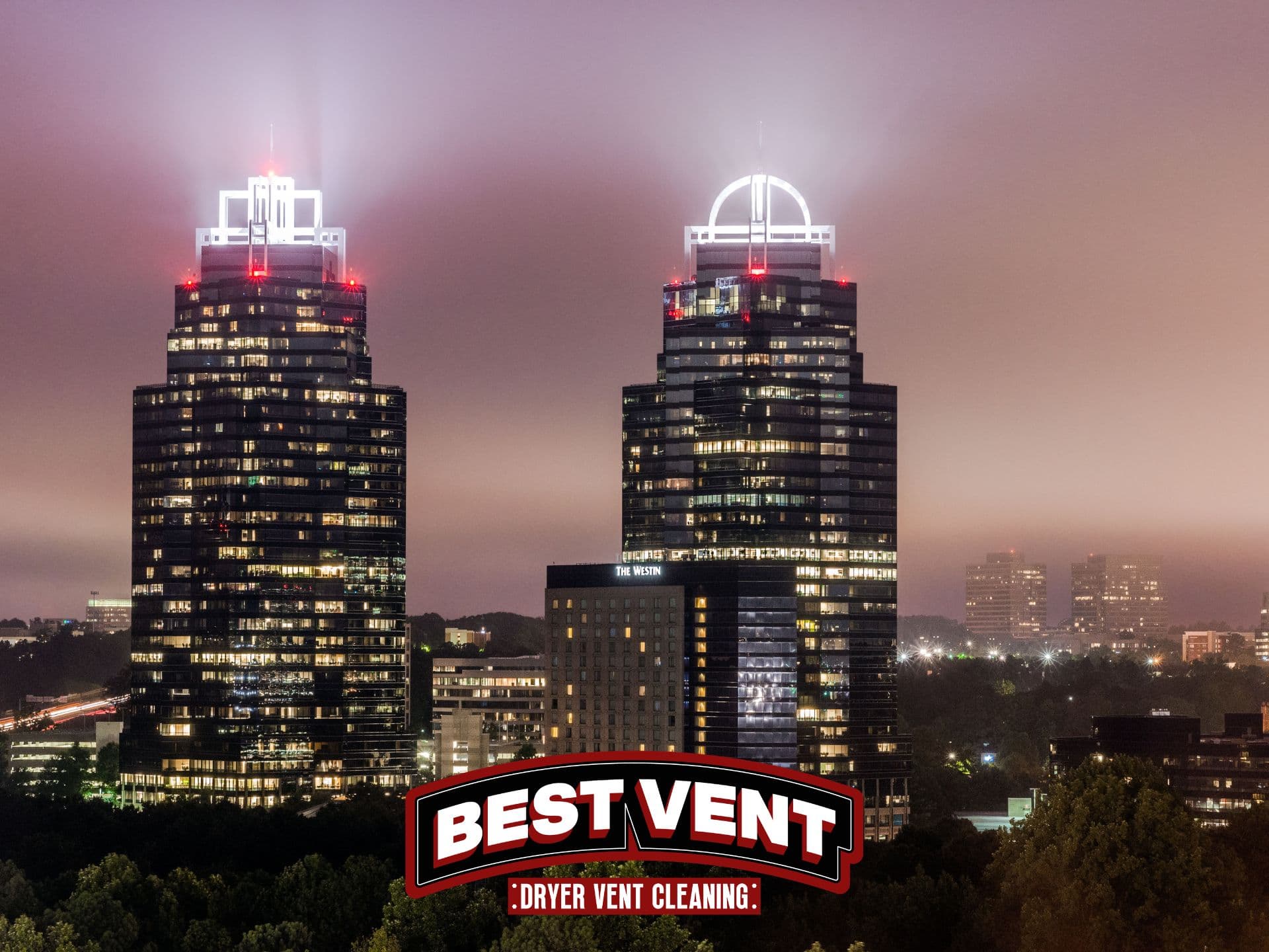 Two illuminated skyscrapers at night under a hazy sky with a Best Vent logo.